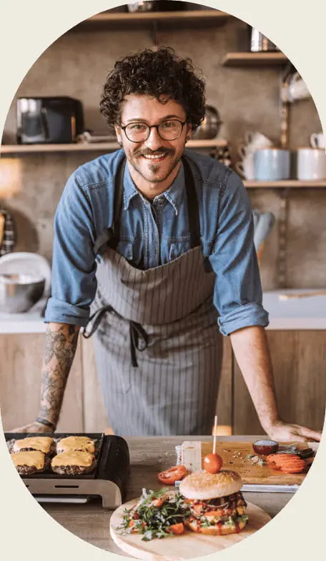 Person preparing gourmet burgers in kitchen - both burgers